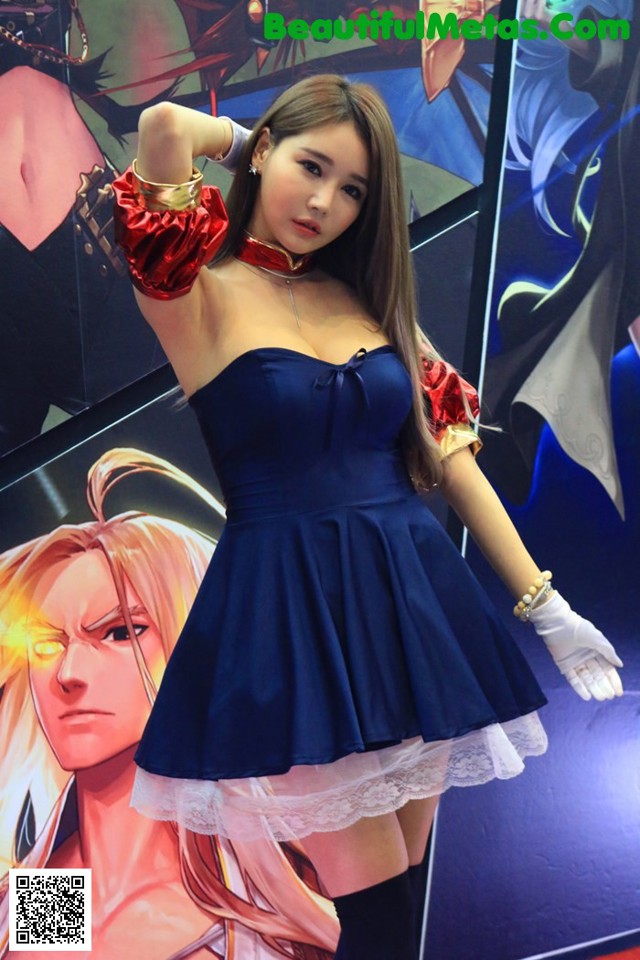 A woman in a blue dress posing for a picture.
