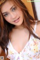 A woman in a white dress posing for a picture.